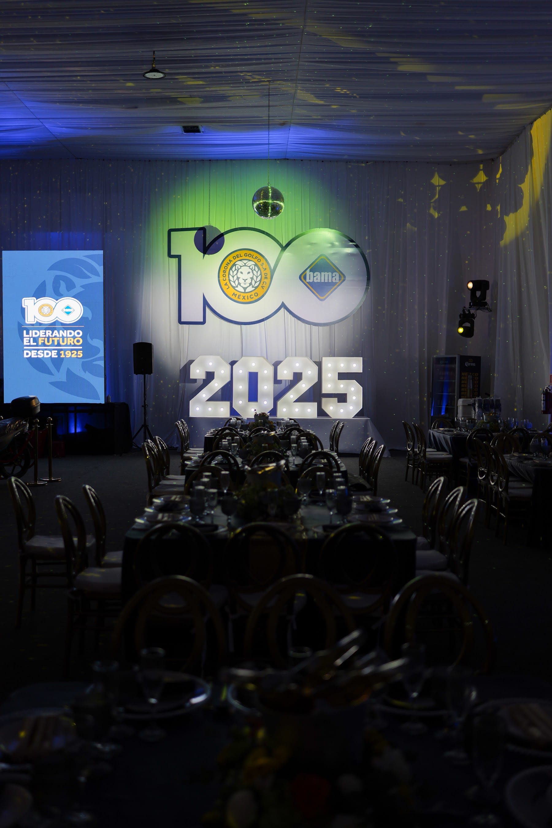 Escenario de aniversario corporativo con pantallas y cifras luminosas